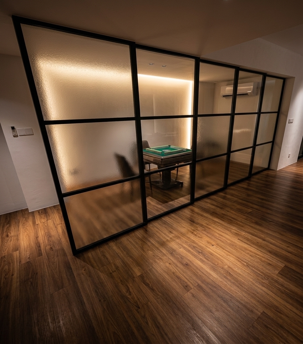 An incredibly lifelike, richly detailed, photorealistic wide-angle interior shot of a sophisticated gaming and entertainment room set in a luxurious contemporary home. The scene is illuminated by warm, indirect LED backlighting and soft ambient glow filtering through the glass, creating an inviting and cozy modern fusion atmosphere. Captured with a professional 24mm architectural tilt-shift lens, emphasizing the rich grain of the SPC wood flooring and the fine texture of the glass panels.

At the heart of the design is a massive sliding partition made of textured, frosted glass panels encased in a sleek, matte black grid frame. Behind this elegant divider lies an intimate, windowless gaming sanctuary. Through the semi-opaque glass, one can discern the subtle silhouettes of a modern automatic mahjong table and a sleek, wall-mounted air conditioner maintaining the perfect climate. The floor features premium, warm-toned SPC stone-plastic composite wood flooring that blends durability with high-end aesthetic appeal, complemented by pristine white walls and exquisite, moody lighting that elevates the space into a highly polished, stylish private enclave.