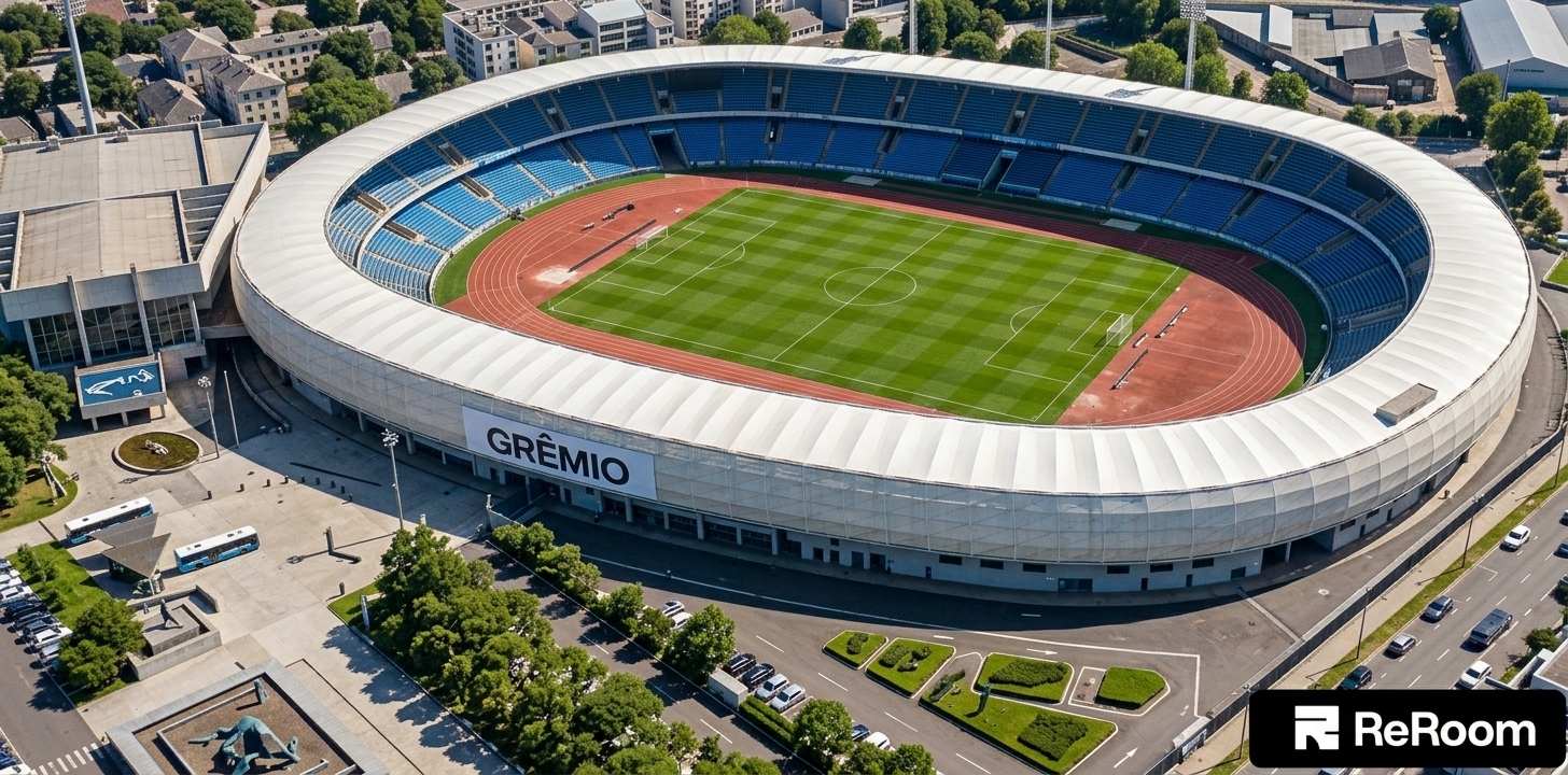 An incredibly lifelike, richly detailed, photorealistic aerial architectural photo of the grand Grêmio stadium set in an expansive, clean urban environment. The scene is illuminated by brilliant, clear midday sunlight, creating a bright, pristine, and energizing atmosphere. Captured with a phase-one camera and a wide-angle tilt-shift lens, emphasizing the smooth, sweeping white curves of the stadium's modern tensile canopy and the rich textures of the surrounding grounds. Inside the bowl, the spectator seating has been transformed into vibrant, deep blue stands (*arquibancadas azuis*) that frame the impeccably manicured green football pitch and terracotta running track. Adhering to a minimalist haven aesthetic, the entire area at the bottom of the image is designed as a clean, spacious parking lot (*estacionamento na parte inferior*) filled with organized parking lanes, sleek modern cars, and neat architectural landscaping of hedges and manicured grass islands, seamlessly anchoring this monumental stadium in its contemporary context.