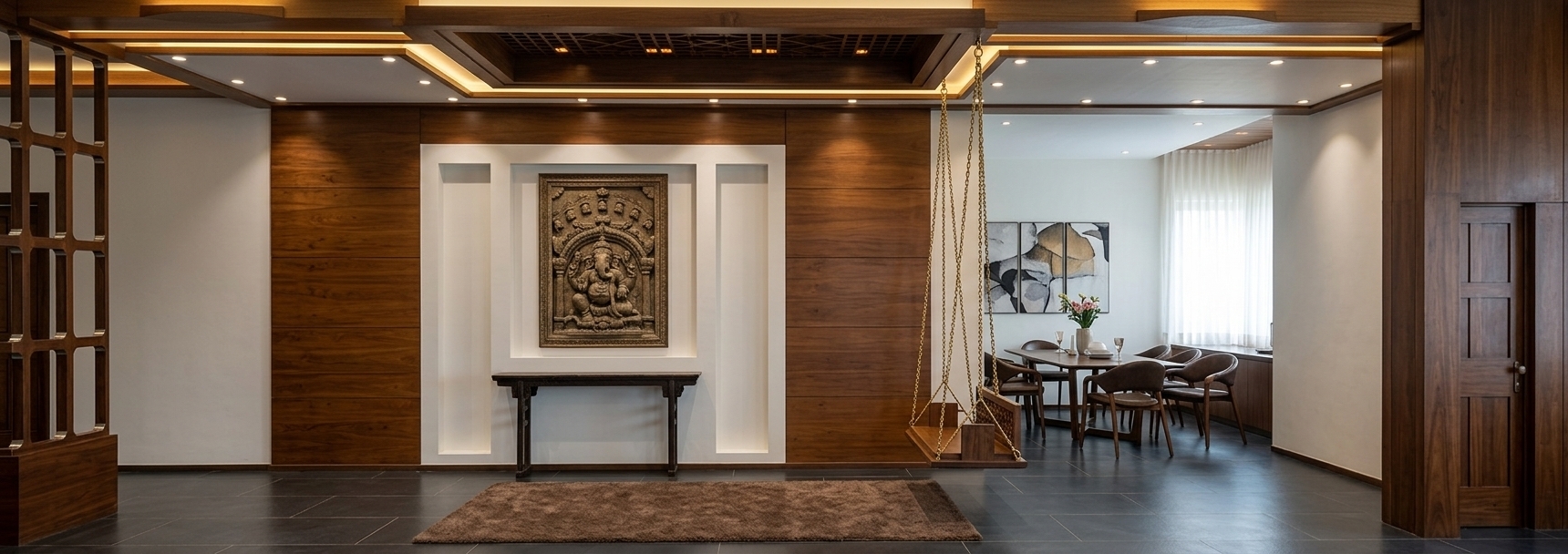 An incredibly lifelike, richly detailed, photorealistic wide-angle interior photo of a grand 'Travelers Trove' living room and adjoining dining space set in a sophisticated urban residence. The scene is illuminated by warm ambient ceiling cove lights, soft brass spotlights, and diffused daylight filtering from adjacent rooms, creating a serene, cultured, and inviting atmosphere. Captured with a 24mm architectural wide lens, emphasizing the rich teak wood grains, smooth dark slate floor tiles, and intricate ceiling lattice work.

At the heart of the room, a magnificent feature wall clad in rich, warm-toned wood panels holds a crisp white recessed niche, showcasing a cherished framed artwork resting above a vintage dark wood console table. To the right, a traditional handcrafted wooden swing hangs gracefully by polished brass chains, offering a nostalgic touch that seamlessly connects the living area to a sunlit dining space equipped with elegant, mid-century modern chairs and a sleek dark dining table. On the left, a dark timber grid partition frame introduces architectural depth, while a plush mocha-brown area rug anchors the deep slate flooring. The space feels worldly and artfully curated, blending global heritage and modern elegance through layered textures, earthy tones, and refined craftsmanship.
