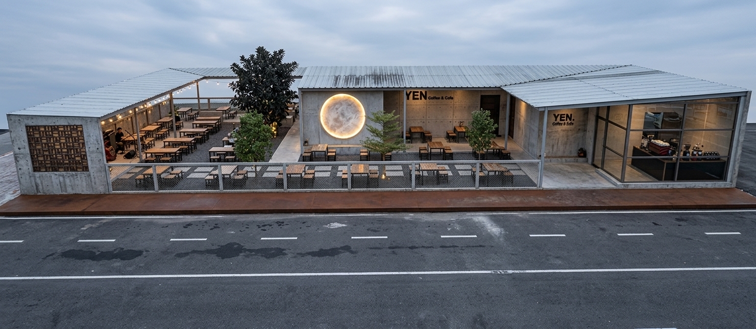 A crisp exterior architectural photograph of the modern open-air cafe, capturing the exact layout, camera angle, perspective, and structural geometry of the reference image during early evening twilight. The long front barrier fence is detailed with visible dark iron wire mesh netting showcasing realistic metallic grid patterns. The walls feature a raw, exposed concrete texture with subtle trowel variations, micro-pores, and natural gray cement weathering. The prominent large circular moon feature on the center facade glows brightly with a warm yellow backlit glow, casting a soft golden light across the textured exposed cement wall and the adjacent outdoor seating area. The seating consists of wooden tables and dark metal stools with natural surface grain and subtle wear. The trees planted throughout the patio have realistic green leaves that catch the soft ambient ambient light, while the corrugated metal roof displays realistic metallic highlights and seams. In the foreground, the smooth asphalt street features fine aggregate details and worn white road dashes. Shot on a full-frame camera with an architectural tilt-shift lens, the lighting beautifully balances the glowing yellow moon light with cool dusk ambient tones, featuring subtle glass reflections, gentle shadow falloff, and faint photographic grain.