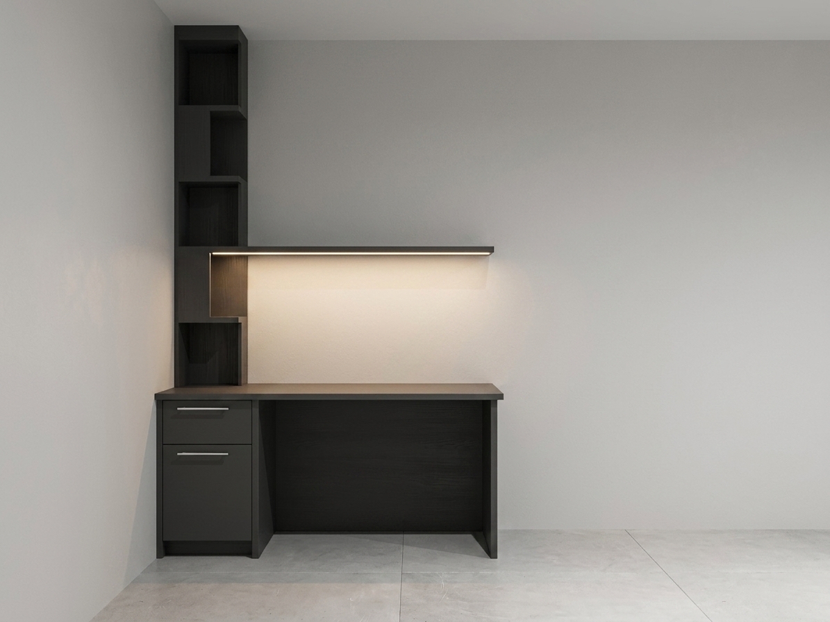 A professional architectural interior photograph of the dark charcoal grey desk and shelving unit situated in the corner of a clean, light-grey room, precisely maintaining the original camera angle, straight-on composition, and geometric layout. The furniture is finished in a smooth matte dark charcoal laminate with delicate edge wear and subtle surface grain visible under high-resolution illumination. Beneath the floating horizontal shelf, a concealed warm-toned LED light strip casts a soft, inviting downlight glowing onto the dark desktop surface and illuminating the rear wall with a gentle light gradient. The drawer handles feature a brushed stainless steel finish with subtle metallic reflections. The surrounding matte painted drywall displays natural, realistic micro-textures and soft ambient occlusion shadows near the floor and corner edges. Shot on a 35mm lens at f/8, the scene exhibits realistic depth, accurate contact shadows beneath the desk base, and clean photographic dynamic range with slight natural grain in the deepest shadows.