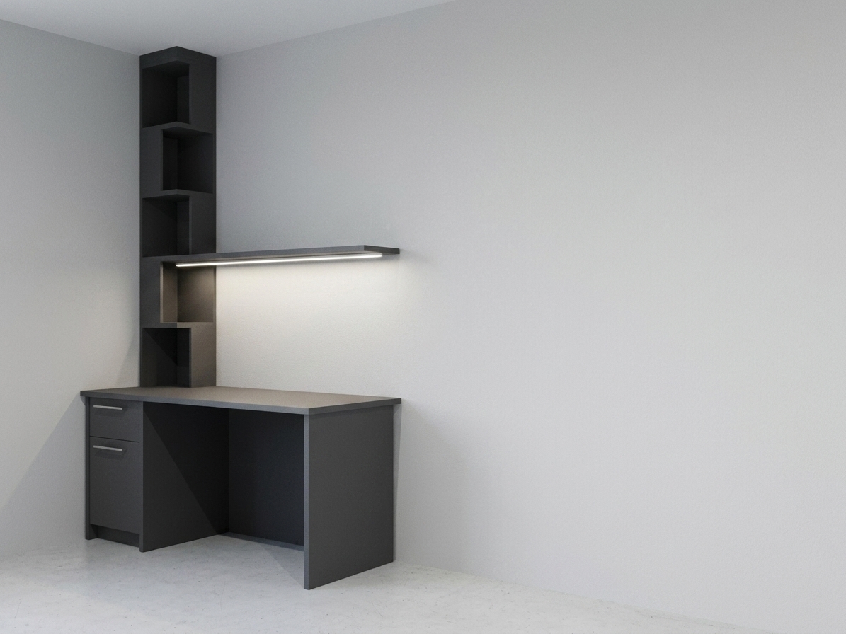 A professional interior photography shot of the exact dark charcoal-grey desk corner setup, captured with a sharp 35mm architectural lens at f/8 for precise detail across the entire scene. The room is illuminated by crisp, neutral 4000K lighting, featuring a continuous LED strip beneath the horizontal shelf that casts a clean, balanced neutral-white wash of light across the matte desktop surface. The dark composite furniture surfaces showcase fine laminate micro-textures, tiny dust specks visible under the illuminated area, and brushed metallic hardware on the drawer fronts. Soft, natural ambient occlusion creates realistic contact shadows where the desk meets the light grey floor and adjoining walls, which exhibit a subtle, realistic paint stipple texture. The photo captures natural camera characteristics including faint sensor grain, gentle lens vignetting at the frame edges, and precise light falloff, maintaining the exact geometric layout, camera position, and structural composition without modification.