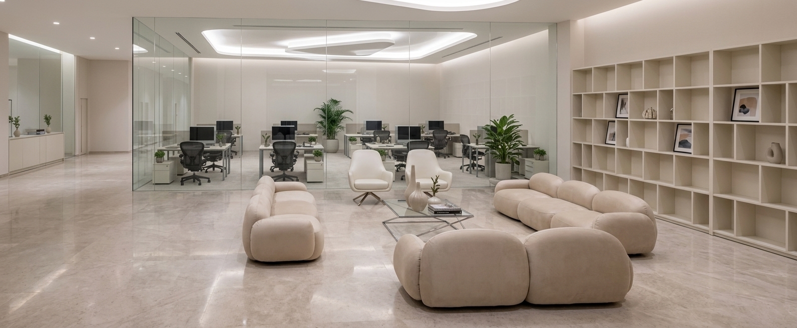 An incredibly lifelike, richly detailed, photorealistic wide-angle interior shot of an upscale coworking space set in a high-end corporate environment. The scene is illuminated by gentle, diffused ambient light and concealed sculptural ceiling fixtures, creating an airy, sophisticated atmosphere. Captured with a professional 24mm architectural lens, emphasizing polished stone floor surfaces, tailored upholstered furniture, and slim metal accents. In the center foreground, a plush, rounded modular sectional sofa in soft champagne fabric framing a geometric glass coffee table with slender chrome legs, adorned with luxury photography books and slender ceramic vases. Opposite the sofa, two refined pearl-white swivel armchairs offer an inviting seating area, backed by a massive floor-to-ceiling grid bookshelf in warm white, neatly housing curated decor and framed abstract art pieces. Beyond crystal-clear floor-to-ceiling glass wall partitions, structured work suites reveal clean-lined desks with dual monitors, ergonomic black mesh chairs, and lush potted greenery, all rendered in a balanced palette of warm white, pearl, champagne, and soft gray tones that convey understated, contemporary elegance.
