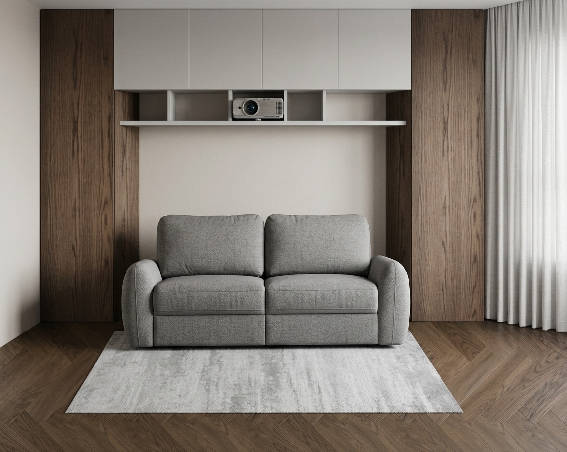 A crisp, professional architectural photograph of the room depicted in the image, captured with a high-resolution full-frame camera and a 35mm lens, strictly preserving the exact layout, geometry, proportions, and placement of every element. Diffused neutral daylight flows naturally from the right side through the full-length pleated off-white curtain, creating soft, realistic light falloff across the rich dark oak herringbone parquet flooring and the grey sofa. The central two-seater sofa features a rich woven fabric texture with subtle natural micro-creases in the cushions and refined seam stitching. It sits precisely over a low-pile light-grey rug with authentic woven surface variations and subtle realistic contact shadows along its edges. The surrounding dark wood veneer panels exhibit deep, realistic natural wood grain patterns with a tactile matte finish. Above, the floating white shelf houses the projector with realistic matte plastic textures, situated under smooth, ultra-matte flat-panel overhead cabinets without synthetic gloss or CGI sheen. The lighting is clean, balanced, and un-stylized, featuring fine photographic optical qualities such as natural ambient occlusions, micro-texture clarity, a soft depth of field, subtle sensor grain, and organic surface details, creating a genuine, believable interior photograph.