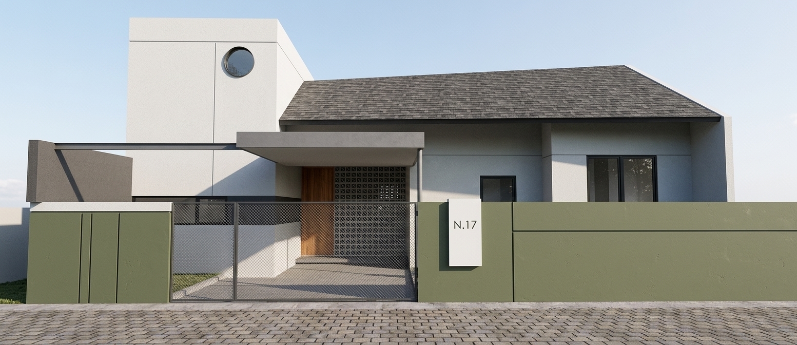 A crisp architectural photograph of the modern minimalist residence under direct midday sunlight, casting sharp, defined diagonal shadows across the white stucco facade. The olive-green perimeter wall displays a subtle matte painted texture, contrasting with the dark asphalt shingle roof, patterned concrete breeze blocks, and smooth natural wood front door. The paved cobblestone street in the foreground features authentic tactile depth and slight surface variations. Photographed with a tilt-shift lens on a professional digital camera, delivering tack-sharp focus across the entire composition, balanced high-dynamic-range exposure, crisp natural contrasts, and a clear pale blue sky overhead.