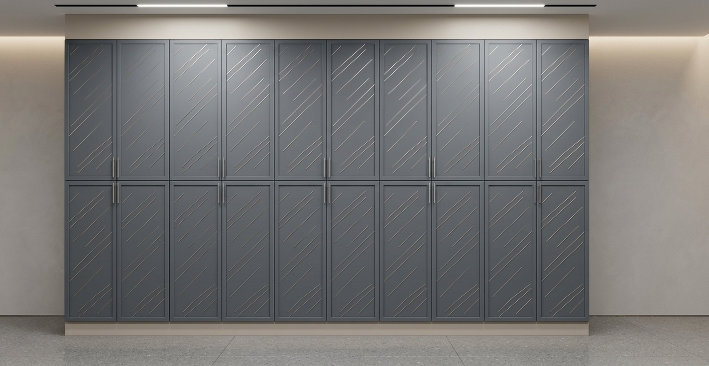 An incredibly lifelike, richly detailed, photorealistic interior architectural shot of a sleek airport staff locker room designed with the contemporary elegance of an upscale walk-in dressing suite, set within an exclusive terminal wing. The scene is illuminated by recessed linear LED ceiling fixtures paired with soft ambient cove lighting, creating a calm, polished, and highly professional atmosphere. Captured with a wide-angle 35mm architectural tilt-shift lens, emphasizing the flawless matte slate-grey laminate finish across the symmetrical double-tiered lockers, the delicate gleam of slim brushed-metal vertical pulls, and the clean, seamless integration of the beige top bulkhead and crisp base plinth. The refined proportions and uncluttered modern aesthetic offer a functional, high-end storage environment tailored to the sophisticated needs of aviation personnel.