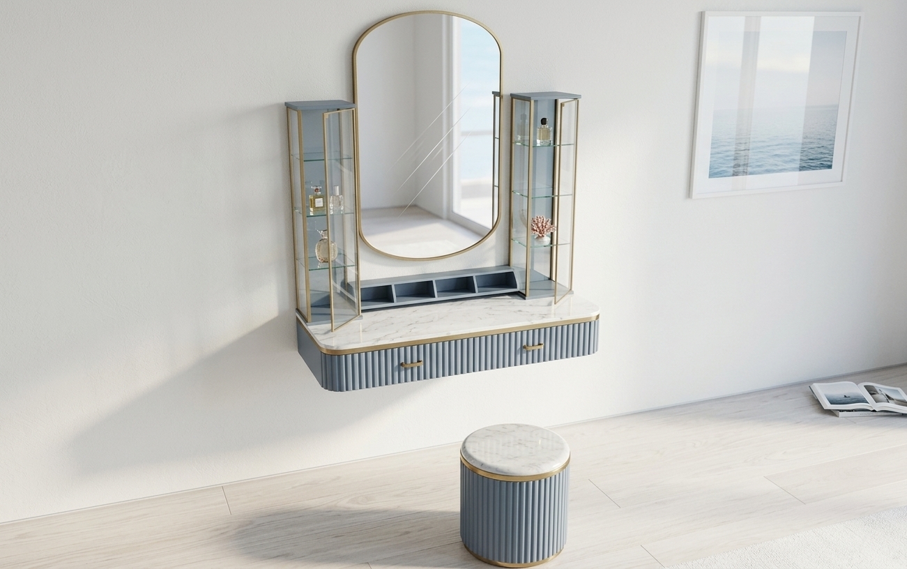 An incredibly lifelike, richly detailed, photorealistic interior photo of an elegant floating vanity unit and matching ottoman set in a sun-drenched coastal bedroom during a crisp winter midday. The scene is illuminated by radiant, soft natural daylight reflecting off surrounding surfaces, creating an airy, fresh, and inviting nautical atmosphere. Captured with a 50mm prime lens at f/2.8, emphasizing the tactile fluted texture of the soft slate-blue cabinetry, polished white marble countertop with delicate veining, warm brushed brass trim, and pristine glass display cases. The sleek, brass-framed pill-shaped mirror reflects the bright room, complemented by a matching cylindrical vanity stool, understated seascape wall art in the background, a curated photography book resting nearby, and subtle touches of lush potted plants that complete this casual yet sophisticated beachside retreat.