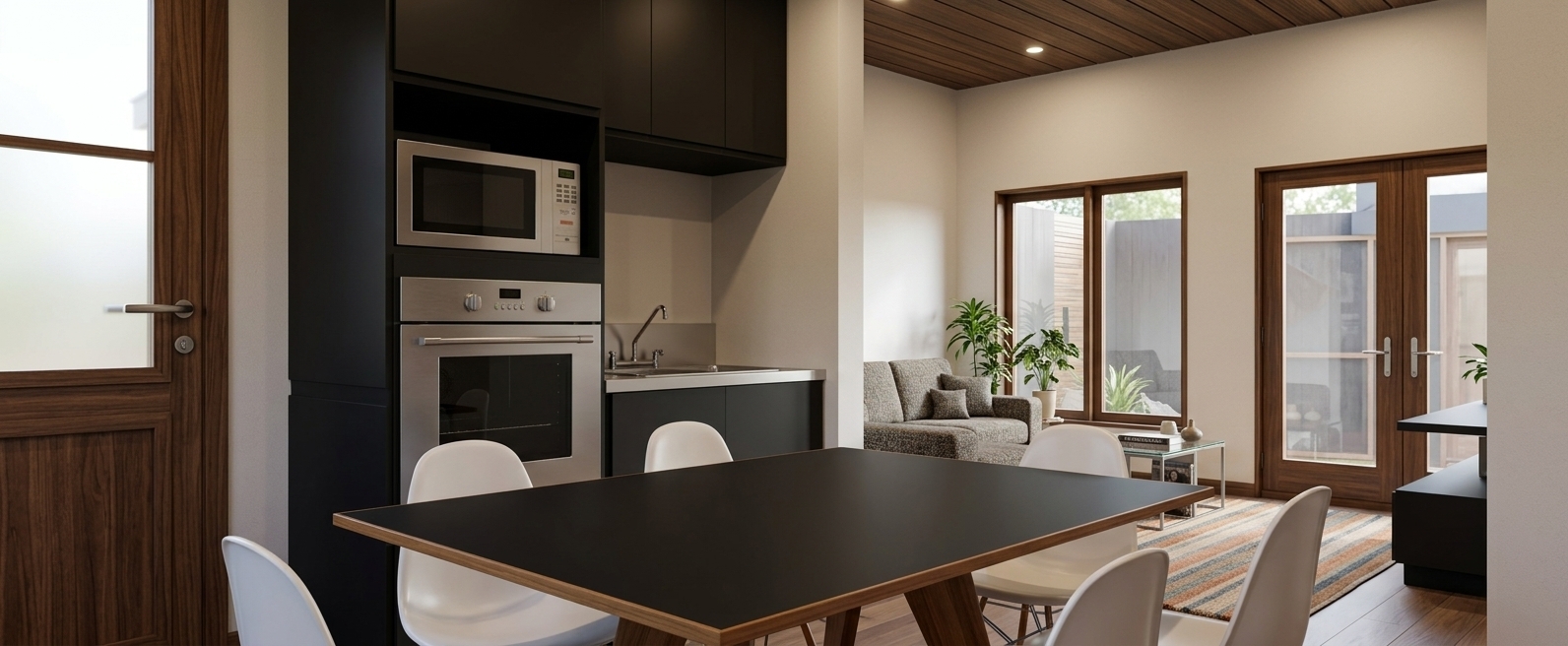 An incredibly lifelike, richly detailed, photorealistic eye-level wide shot of a mid-century modern kitchen and dining space set in a warm, sophisticated residential interior. The scene is illuminated by soft daylight diffusing through generous timber-framed glass doors and gentle overhead ambient warmth, creating a calm, uncluttered, and timeless atmosphere. Captured with a 35mm full-frame architectural lens at f/8, emphasizing rich walnut and teak wood grains, smooth matte cabinetry finishes, and crisp linear geometry. In the foreground, an iconic dining table featuring a sleek black surface with exposed wooden edges is surrounded by organic, white molded shell chairs. Adjacent stands a seamless, functional matte-black appliance tower housing an integrated stainless steel oven and microwave beside a clean countertop. The visual flow extends past a rich walnut door into an inviting living area under a dark slatted wood ceiling, where a cozy textured sofa, an earthy striped area rug accented with subtle oranges and muted blues, a curated photography book on a glass coffee table, and verdant indoor plants effortlessly embody retro mid-century comfort and elegance.