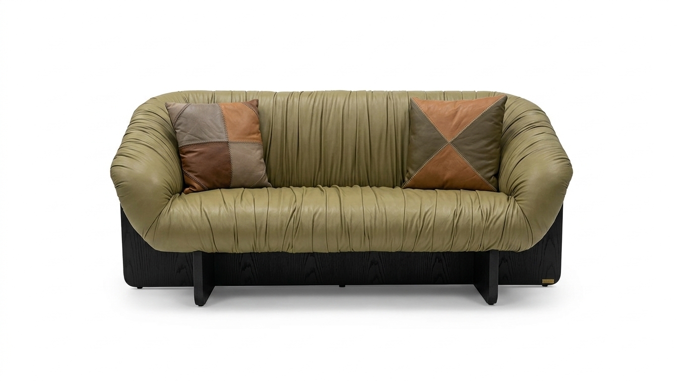 Studio product photograph of the exact ruched olive-green leather sofa and patchwork leather cushions isolated on a seamless, clean white studio background with soft, natural contact shadows underneath. The sofa maintains its identical form, gathered upholstery folds, and perspective, with its wooden base and legs recolored to a rich matte black finish featuring subtle wood grain texture. The scene is evenly lit by diffused studio softbox lighting to accentuate the subtle sheen and realistic micro-textures of the green leather, captured sharply on a 50mm lens with neutral color temperature and faint photographic grain.
