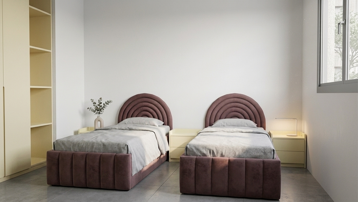 A realistic photograph of the bedroom scene preserving the exact layout, geometry, and composition, captured with a 35mm lens in soft natural daylight mixed with warm bedside lamp glow. The wardrobe facades on the left feature a smooth matte finish matching the pale cream color of the nightstands. The two arched headboards and bed frames showcase rich, textured burgundy upholstery with tactile fabric weave, complemented by casually rumpled grey linen bedding. Soft shadows, realistic fabric draping, subtle surface reflections on the concrete floor, faint dust motes in the light beam, and natural film grain enhance the authentic photographic look.