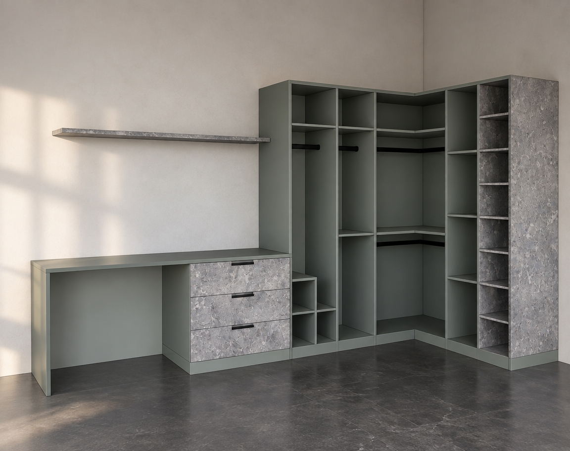 A real interior photograph capturing the exact corner wardrobe and desk unit, strictly preserving the camera angle and geometry. The cabinetry features smooth, matte sage-grey laminate surfaces, while the drawer fronts and right exterior panel showcase tactile, cool grey mottled stone textures with realistic micro-relief. Soft, diffused natural daylight enters from the side, casting gentle ambient occlusion and realistic soft shadows inside the open compartments and under the hanging rails. The plain walls reveal subtle plaster texture, and the dark flooring reflects faint, diffuse highlights. The image is rendered with crisp optical clarity on a 35mm lens, featuring natural depth, subtle surface micro-imperfections, and balanced exposure that brings authentic architectural realism to the space.