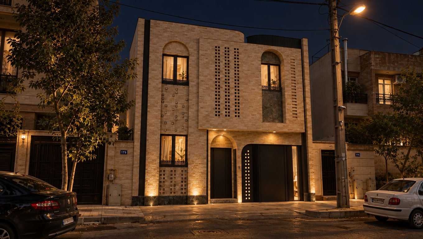 An authentic night architectural photograph of the exact scene, capturing the textured beige stone building under a dark evening sky. Warm ambient illumination glows from the arched windows and recessed entrance fixtures, grazing across the masonry and perforated relief details. Diffused street lighting casts realistic, soft shadows across the asphalt road, parked cars, and utility pole, while vehicle finishes and window panes show subtle dark reflections. Shot on a full-frame camera with balanced dynamic range, the image features realistic low-light exposure, natural contrast between warm artificial lights and cool night shadows, fine sensor grain, and gentle edge vignetting.