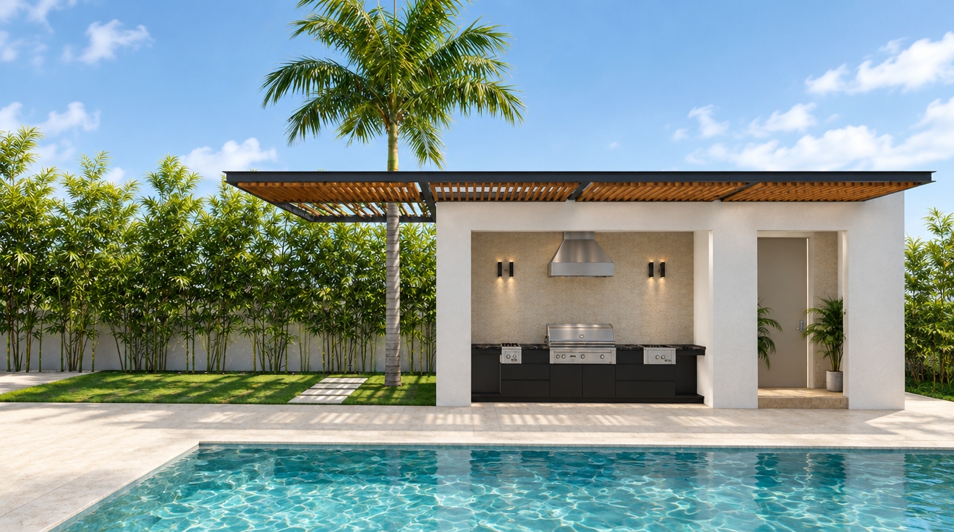 An incredibly lifelike, richly detailed, photorealistic wide-angle architectural landscape photograph of a contemporary minimalist outdoor kitchen pavilion and pool terrace set in a sun-drenched Caribbean residential garden. The scene is illuminated by bright tropical mid-morning sunlight that filters softly through horizontal overhead louvers, casting crisp, elongated shadows across the patio and creating a serene, sophisticated resort atmosphere. Captured with a full-frame architectural camera and a 24mm tilt-shift lens, emphasizing the tactile plaster of smooth white stucco walls, the natural honey tones of warm teakwood slats, and the rippling, crystal-clear turquoise water of the foreground swimming pool with realistic caustics. Under the clean-lined roof structure, framed by dark charcoal steel, the integrated outdoor kitchen showcases professional-grade stainless steel appliances—including a central barbecue grill, twin side burners, and an overhead extraction hood—set into honed black granite countertops with seamless matte cabinetry. A dense perimeter screen of slender green bamboo stems rises gracefully behind the light sandy-toned ground and lawn, accompanied by a tall, elegant palm tree centered neatly beside the open pergola structure, flawlessly uniting understated minimalist modern design with lush, organic island beauty.