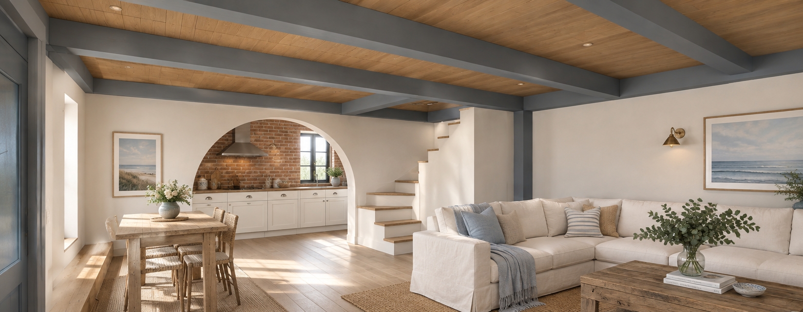 An incredibly lifelike, richly detailed, photorealistic interior perspective of an open-concept coastal living space. The scene is illuminated by soft, natural morning daylight streaming in through the kitchen window, creating a breezy, serene atmosphere. Captured with a 24mm wide-angle lens, the composition emphasizes the warm oak-clad ceiling rafters contrasted by cool, matte-gray structural beams.
In the foreground, a plush, off-white linen sectional sofa invites relaxation, paired with a reclaimed wood coffee table topped with a glass vase of fresh eucalyptus. Through the elegant masonry archway, the kitchen reveals weathered red brick walls and crisp, shaker-style cabinetry adorned with polished nickel hardware. The space is accessorized with woven seagrass rugs and nautical-inspired ceramic accents that ground the room. The transition between the sleek dining area and the cozy lounge is seamless, with the depth of field softly blurring the staircase, highlighting the tactile quality of the light wood treads and the crisp, clean finish of the plaster walls. The entire space breathes with a minimalist, airy coastal aesthetic, where every material—from the smooth wood grain to the textured brick—is captured with impeccable clarity and depth.