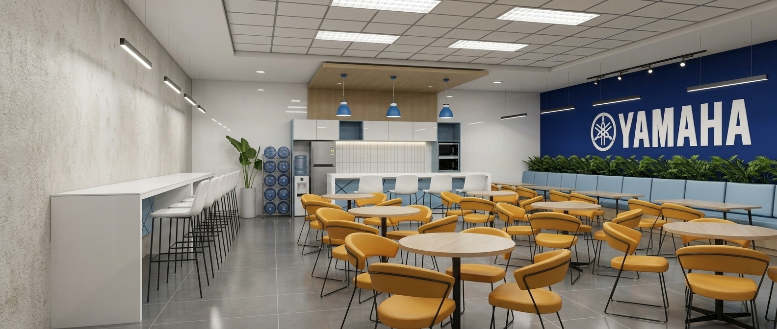Photorealistic business lounge interior render based on the 3D model: Isotop round tables with curved yellow-orange chairs on black metal legs. Booth seating with light blue cushions alongside the right dark blue accent wall displaying the Yamaha logo, lit by track lights. Polished 60x60 gray vinyl floor tiles, ceiling grid with 60x120 troffers and linear LEDs. Background kitchenette featuring glossy white laminate cabinets, vertical white tile backsplash, and blue pendant lights under a wood drop ceiling. Counter with blue laser-cut modesty panels and white barstools on black legs. Left wall in textured stucco, remaining walls in glossy white.